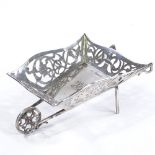 An Edwardian novelty silver wheelbarrow, pierced and engraved foliate fretwork surround and rotating
