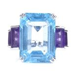 A large 18ct white gold blue topaz and amethyst cocktail ring, with openwork bridge, emerald-cut