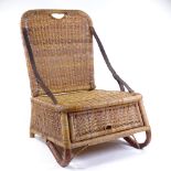 An unusual Victorian woven wicker fisherman's folding chair, with adjustable leather arm straps