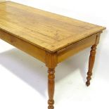 An 18th century French chestnut kitchen table with plank top, frieze drawer and slide, raised on