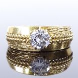 A large 18ct gold 1.09ct solitaire diamond gysy ring, with pierced braided shoulders and textured