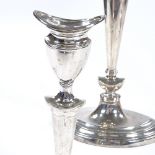 A pair of George V silver table candlesticks, shaped oval form with tapered stick, reeded border and