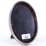 A George V silver and tortoiseshell-fronted oval strut photo frame, by Sanders & Mackenzie,
