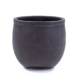 A Chinese patinated bronze pot on 3 feet, signed under base, height 10cm, rim diameter 10.5cm,