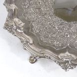 A George II circular silver salver, scalloped foliate rim with relief embossed floral decoration, by