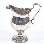 A Britannia Standard silver pedestal cream jug, with gadrooned rim and foot with acanthus leaf