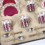 An Aynsley coffee set with silver holders, and matching silver spoons, missing 1 cup Three cups have