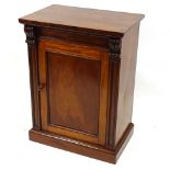 A small Victorian mahogany side cupboard, with panelled door and carved pilasters, width 26.5",