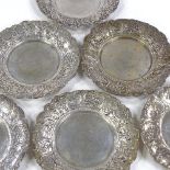 A set of 6 German silver coasters, relief embossed decoration with floral and playing children