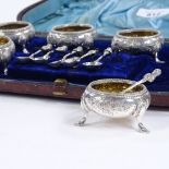 A set of 6 silver plated salt bowls and spoons, floral embossed decoration with gilt interiors and