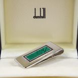 DUNHILL - a sterling silver and enamel money clip, engine turned green enamel sunburst panel with
