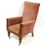 A William IV upholstered fireside armchair, with carved mahogany show wood front