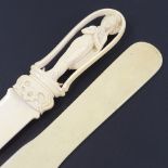 A Chinese ivory paper knife with relief carved handle in the form of a deity, length 30cm, and a