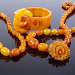 Various bakelite and simulated butterscotch amber, including buckle bracelet, graduated bead