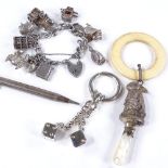 Various silver and jewellery, including charm bracelet, bunny rattle, and silver propelling pencil