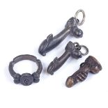 A group of 4 unmarked cast-metal erotic jewellery, including ring and pendants, largest pendant