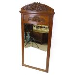 A carved walnut-framed wall mirror, height 5'8", width 33"