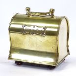 A Victorian shaped brass moneybox with swing handle, length 12cm Good condition but feet are