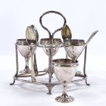 An electroplate egg cruet on stand, with matching spoons