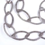 A long modernist unmarked silver necklace, openwork textured marquise panels, panel length 51.3mm,