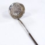 A George III silver toddy ladle, relief embossed twisted floral decoration with inset coin bowl