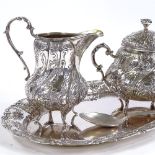 A German silver 3-piece teaset, comprising cream jug, sugar bowl and tray, relief embossed foliate
