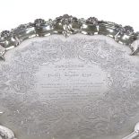 A George III circular silver salver, scalloped rim with cast foliate border and engraved floral