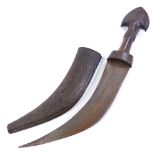 An Antique Arab dagger with carved and shaped horn handle, original leather-covered scabbard,