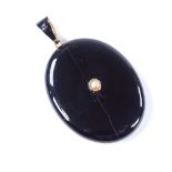 A Victorian unmarked gold black enamel split-pearl and onyx locket memorial pendant, with vacant