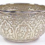 An Indian unmarked silver bowl, relief embossed floral and bird decoration, diameter 10cm, 5oz