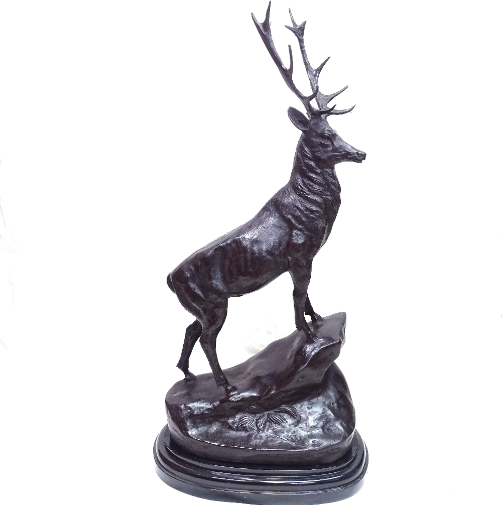 After Joules Moigniez, a patinated bronze sculpture depicting stag on a rocky outcrop, on polished