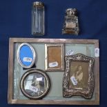 A rectangular silver-fronted photo frame, 4 other silver-fronted photo frames, and 2 silver-topped