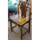 A Chinese elm altar chair, with carved decoration, seat width 50cm