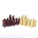 A set of cream and red stained resin chess pieces, King height 19.5cm