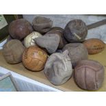 Assorted leather rugby balls and footballs