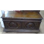 An 18th century Continental oak coffer, the relief carved front decorated with knights in armour,