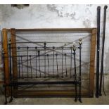 A Victorian iron and brass 4'6" bed, with box-sprung base and rails