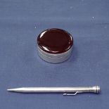 A silver circular box with cherry amber top, and a sterling silver propelling pencil