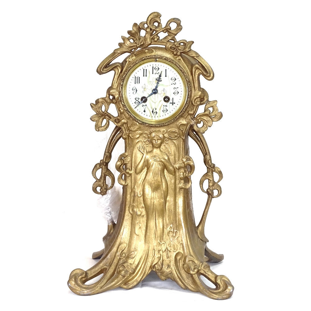 A French Art Nouveau gilded spelter-cased mantel clock, ornate stylised case with relief moulded