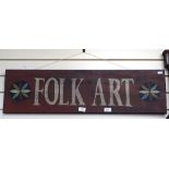 A painted wood "Folk Art" sign, length 89cm