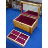 A polished wood jewellery box with fitted tray