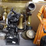 A black painted resin sculpture, depicting intimate wrestlers, and a Vintage brass candlestick