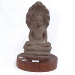 A large moulded stone seated Buddha on wood plinth, overall height 37cm