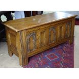 An Ipswich oak design coffer with carved and panelled front, on stile legs, W103cm, H52cm