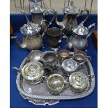 A collection of silver plated coffee pots, teaware and serving trays