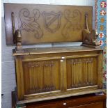 A reproduction carved and linenfold panelled oak monk's bench, bears label for L Marcus Ltd