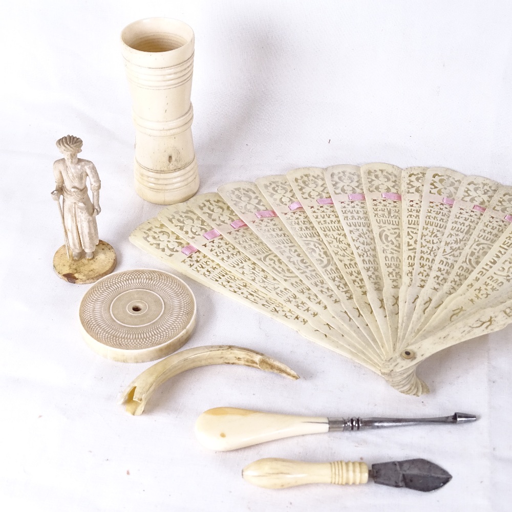 Various ivory and bone items, circa 1900, including dice shaker, fan etc