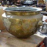 A large Oriental 2-handled brass bowl, engraved floral decoration with kylin ring handles,