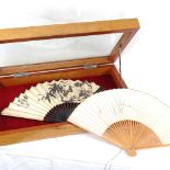 2 Chinese printed fans, in display case