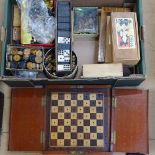 A large quantity of various chess pieces, draughts pieces, dominoes and folding boards